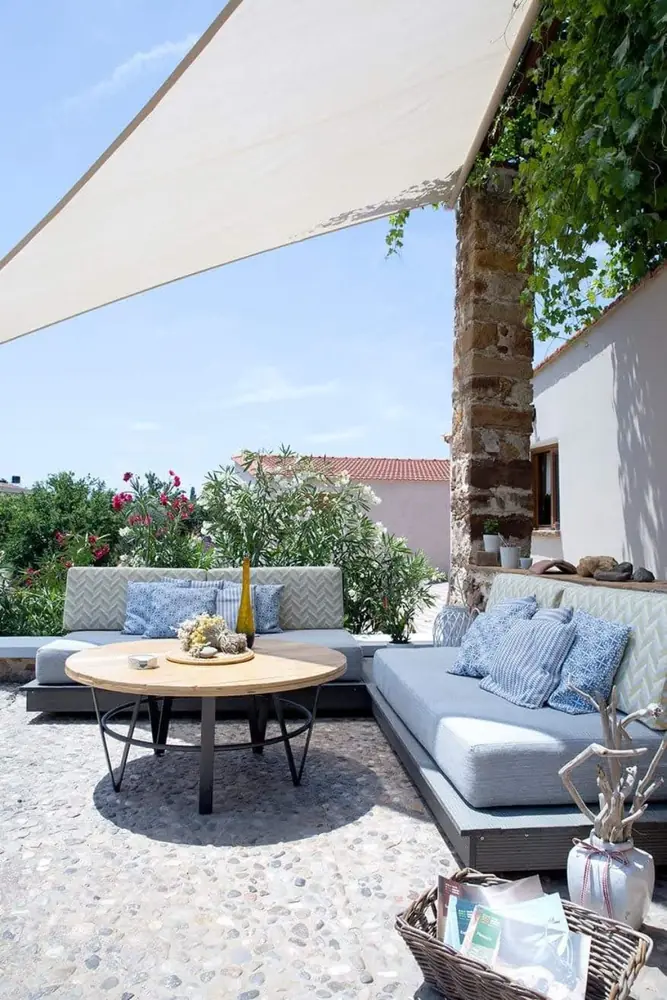 Courtyard sofa and table in the garden of Voulamandis House in Chios