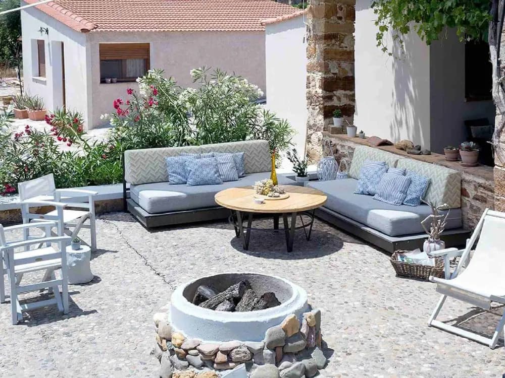 Outdoor courtyard lounge with sofas at Voulamandis House in Kampos, Chios