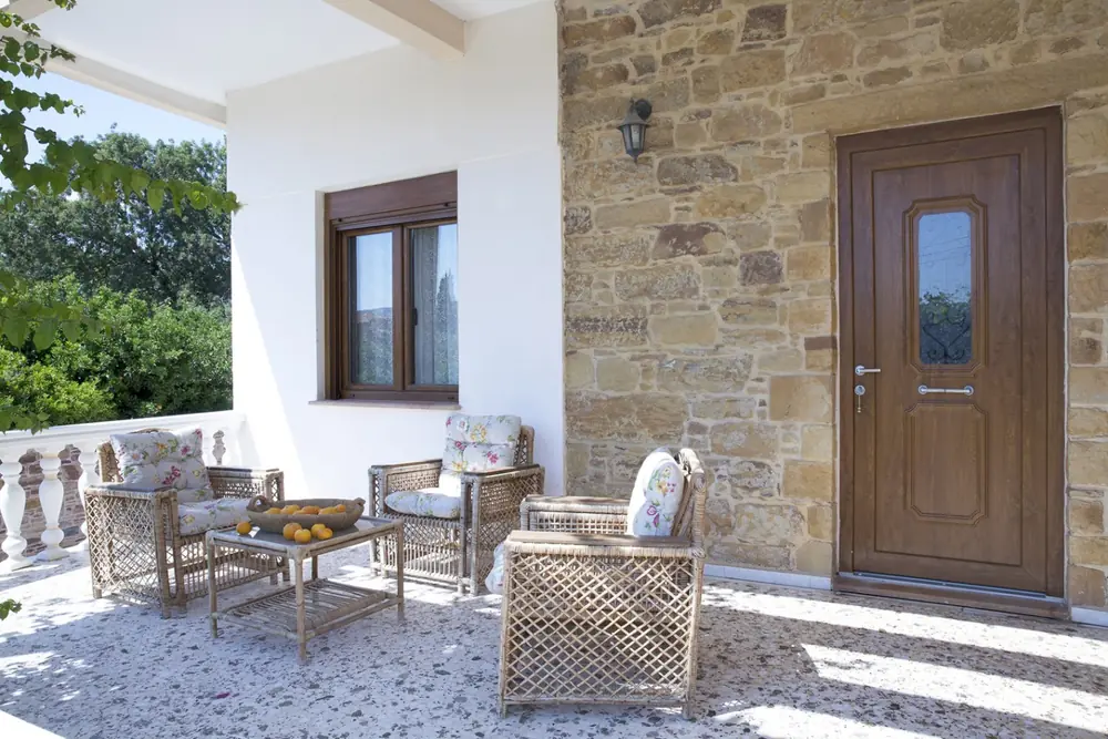 Stone terrace with outdoor seating at Voulamandis House in Kampos, Chios